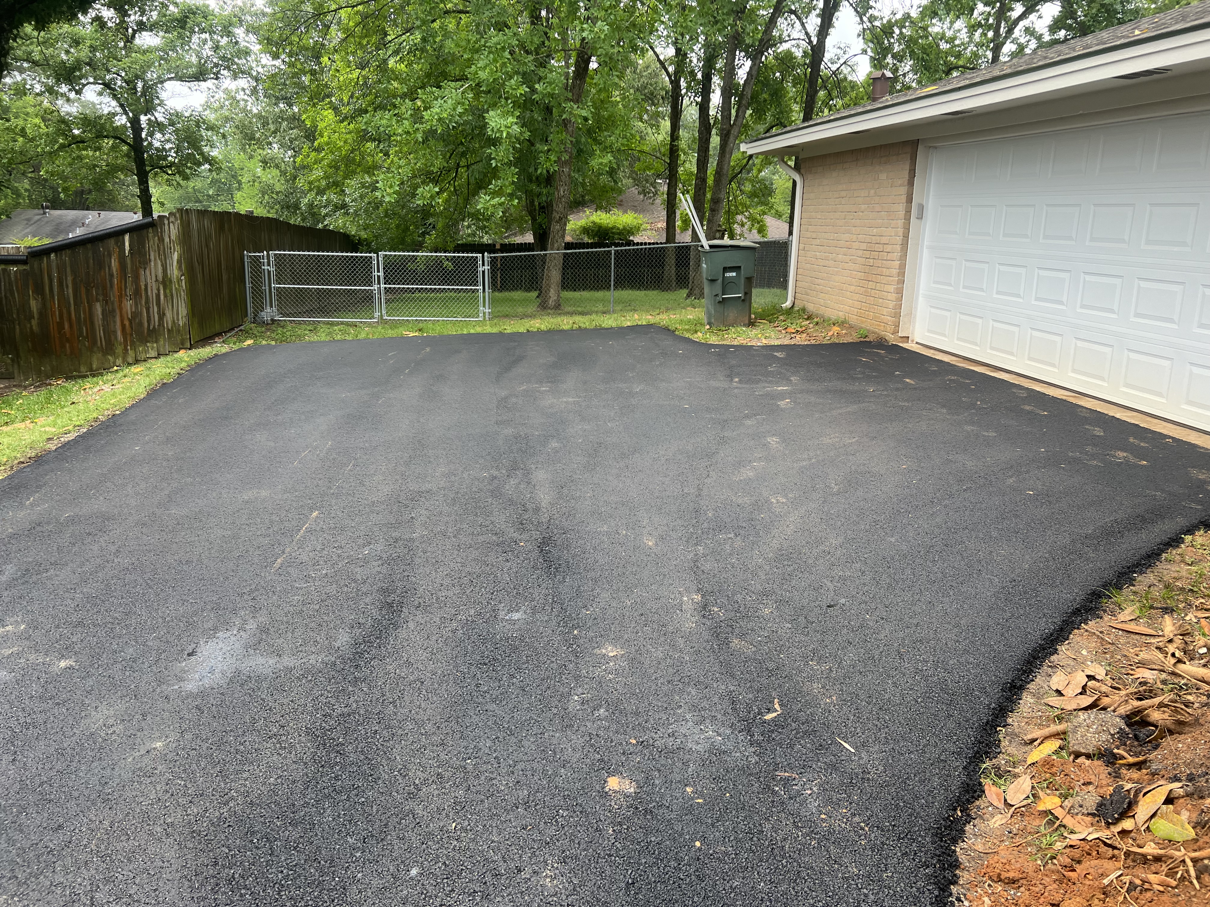 A residential asphalt driveway laid by JBC Excavation is pictured.